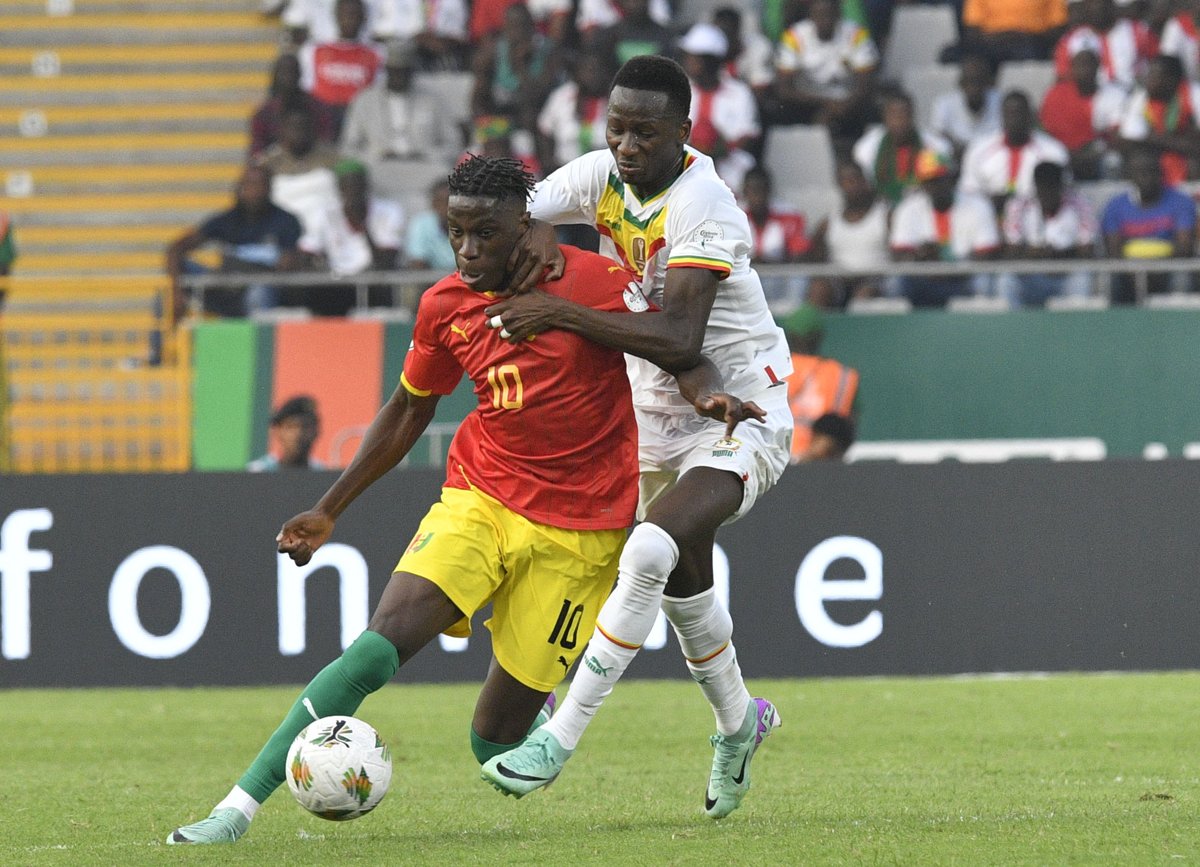 Guinea's Moriba Kourouma challenged by Senegal's Pape Matar Sarr at the 2023 Africa Cup of Nations